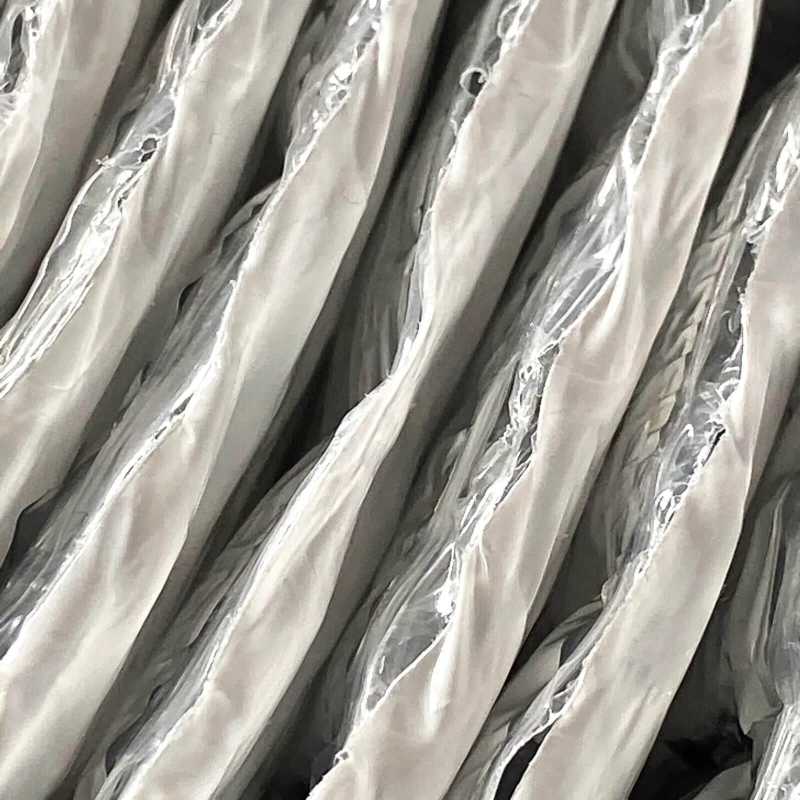 Closeup of ES® RFID double bubble insulation with white polyethylene on one side and reflective foil on the other.