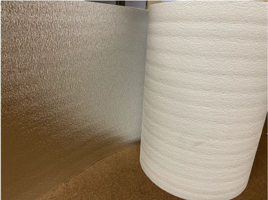 Roll of ES® RFID Reflective Foam insulation with white on one side and foil on the other.