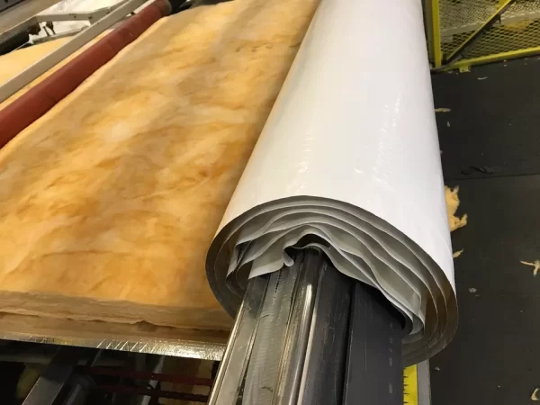 Roll of ES® Faced Fiberglass being manufactured