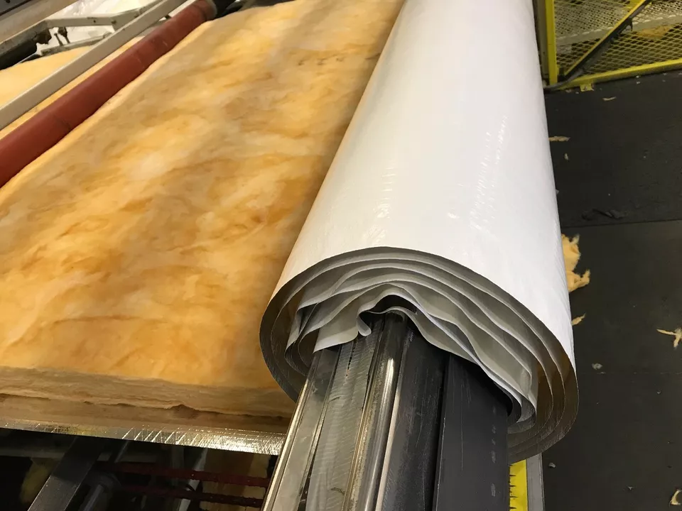 Roll of ES® Faced Fiberglass being manufactured