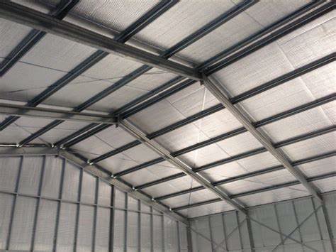 Reflective foam insulation installed in a metal building to reduce radiant heat transfer and improve temperature control.