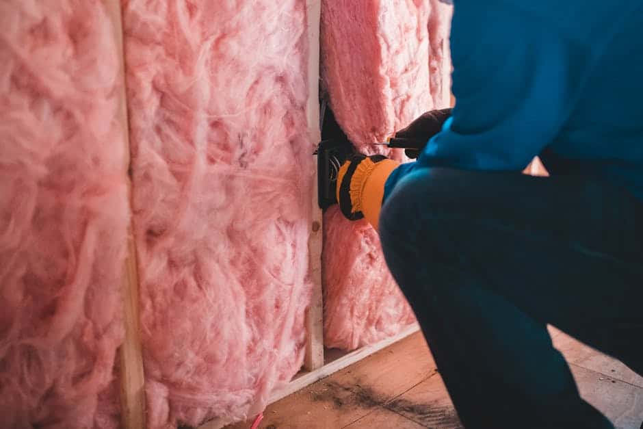 Fiberglass batt insulation laid between attic ceiling joists.